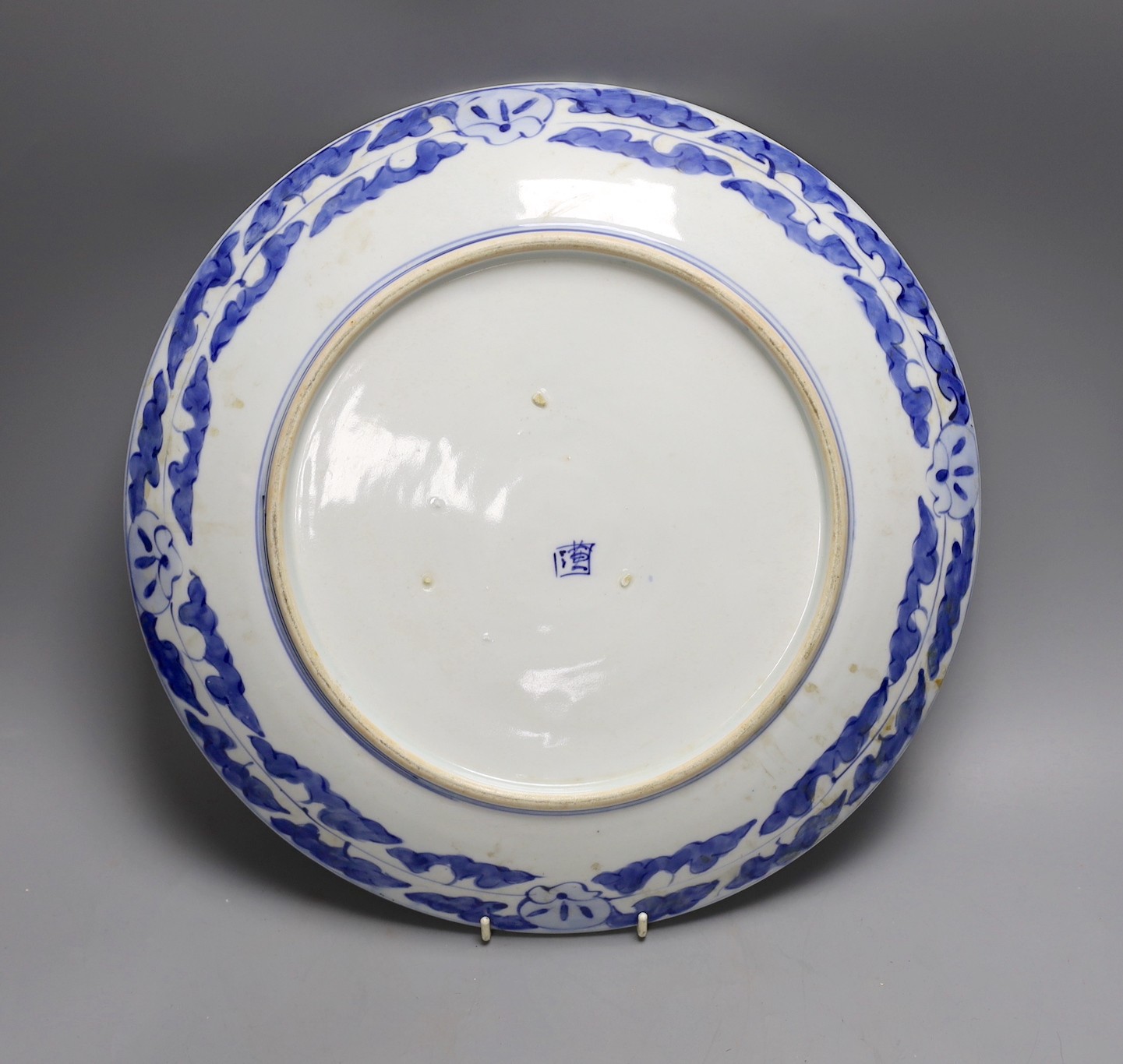 A Japanese blue and white landscape porcelain charger, marked to base, 38cm diameter